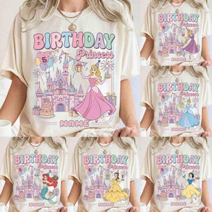 May include: Cream-coloured t-shirts with a colourful "Birthday Princess" graphic. Each shirt features a different princess, a castle, and the number "5". The design includes the word "NAME" below the graphic.
