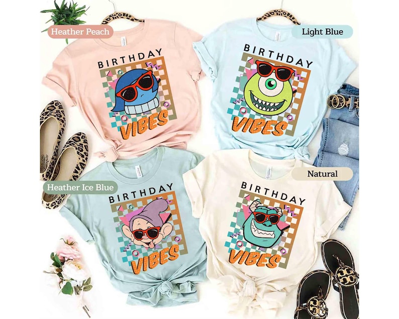May include: Four pastel-coloured t-shirts, each featuring a cartoon character wearing sunglasses and the words "BIRTHDAY VIBES". The shirts are in heather peach, light blue, heather ice blue, and natural. The design has a retro feel.