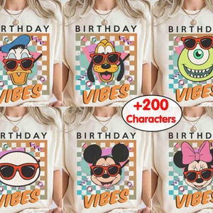 May include: Cream-coloured t-shirts with cartoon characters wearing sunglasses. Each shirt displays "BIRTHDAY" above the character and "VIBES" below. Characters include Donald Duck, Pluto, Mike Wazowski, a white circle, Mickey Mouse, and Minnie Mouse.