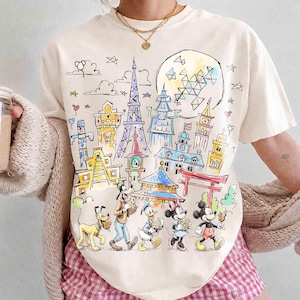 Comfort color Mickey & Friends Disney Epcot Shirt, Epcot World Tour 2026, Disneyland Family Vacation, Snacks Drinking Around The World Shirt