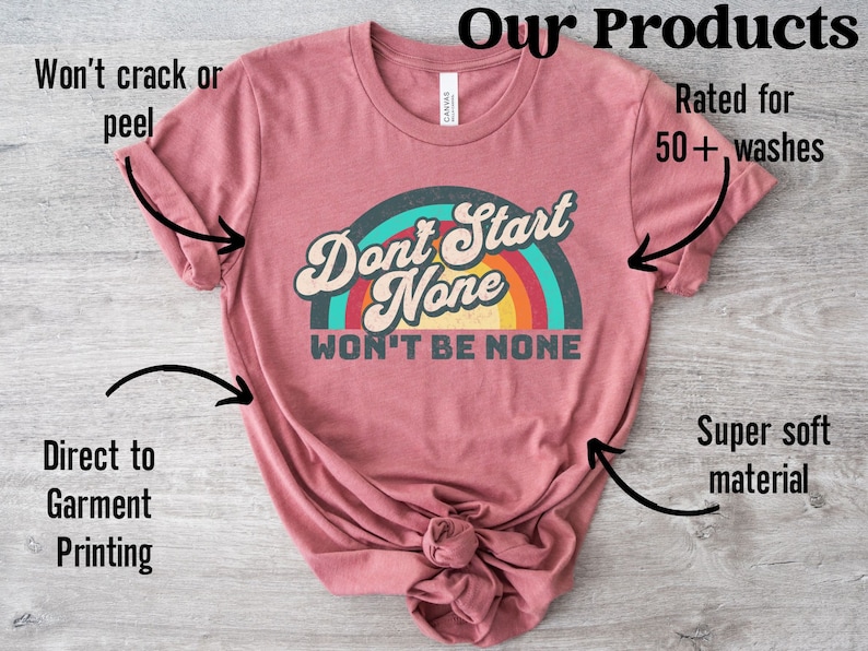 May include: A maroon t-shirt with a rainbow graphic and the text "Don't Start None Won't Be None". The shirt is made of a super soft material and is rated for 50+ washes.