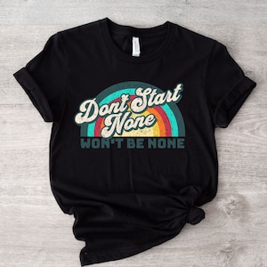 May include: Black t-shirt with a rainbow graphic and the text "Don't Start None Won't Be None".