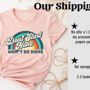 May include: A pink t-shirt with a rainbow graphic and the text "Don't Start None Won't Be None".