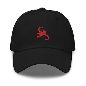 May include: A black baseball cap with a red embroidered monkey design.