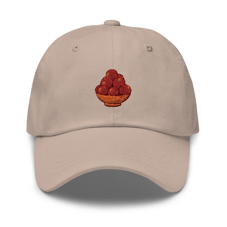 A hat with gulab jamun in a bowl on it