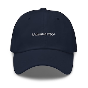May include: A navy blue baseball cap with the text "Unlimited PTO*" embroidered in white. The cap has a curved brim and a structured crown. This hat is a casual accessory.