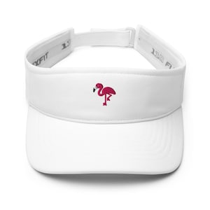 May include: White visor with a curved brim and adjustable strap. A pink flamingo is embroidered on the front. The visor is designed to shield the eyes from the sun.