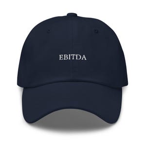 May include: A navy blue baseball cap with the word "EBITDA" embroidered in white on the front.