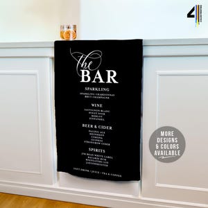 May include: Black bar menu with white text listing drink options: Sparkling, Wine, Beer & Cider, and Spirits. The menu includes Sparkling Chardonnay, Pinot Noir, and Jim Beam White Label. A glass with a slice of orange sits on the counter.