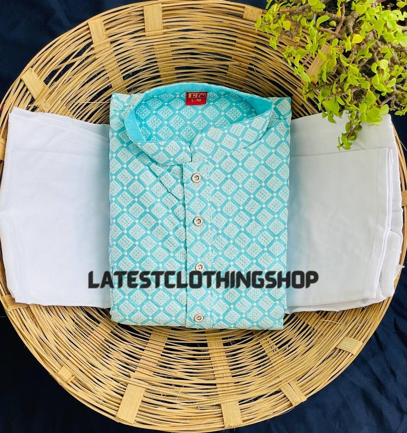 May include: A light blue kurta with a white geometric pattern. The kurta has a mandarin collar and a button closure. The kurta is paired with a white bottom.