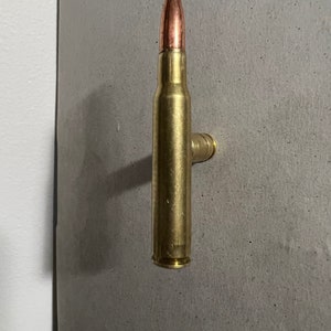 Rifle cartridge cupboard door handle