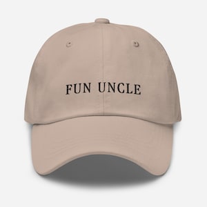 May include: A beige baseball cap with the text "FUN UNCLE" embroidered in black.