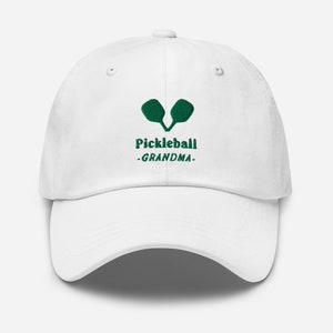 May include: White baseball cap with green embroidery of two pickleball paddles and the text "Pickleball -GRANDMA- "