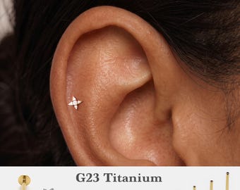 May include: A gold-tone star-shaped flat back stud earring with small clear stones, shown inserted in an ear cartilage piercing. The text G23 Titanium, 16g, 18g, 20g, and 5mm, 6mm, 8mm, 10mm is visible alongside various post lengths.