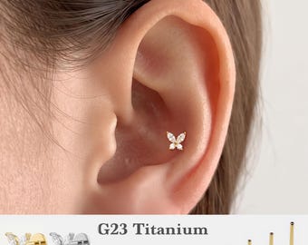 May include: A gold-tone butterfly-shaped ear stud featuring four marquise-cut clear stones. The jewelry is made of G23 titanium and is available in 16g, 18g, and 20g gauges with post lengths of 5mm, 6mm, 8mm, and 10mm as shown in the image.
