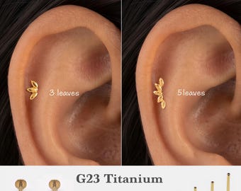 May include: Gold-colored G23 titanium flat back stud earrings featuring leaf-shaped designs. One option displays 3 leaves, while the other shows 5 leaves. The text indicates gauges of 16g, 18g, 20g and lengths of 5mm, 6mm, 8mm, 10mm.