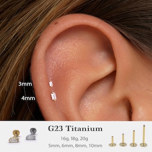 May include: An ear with two small, rectangular earrings, one 3mm and the other 4mm. The earrings are set in the ear. Below, the text "G23 Titanium" is displayed, along with size and gauge information. Additional earring studs are shown.