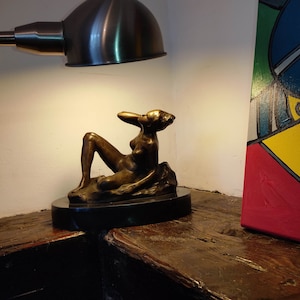 Bronze statue of a naked woman in the style of Camille Claudel