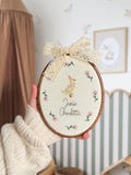 Baby name sign embroidered with storybook goose and florals, newborn birth announcement plaque, oval nursery wall hanging, gift for new mum product logo