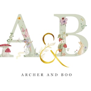 May include: A watercolor illustration of the letters A and B with floral and nature-themed designs. The letter A features a fairy, a mushroom, and a dragonfly. The letter B features a rabbit and strawberries. The text "ARCHER AND BOO" is written below the letters.