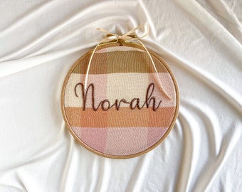 First name wall hanging | nursery and child’s bedroom decor | embroidered on pink, peach, tan and cream large gingham