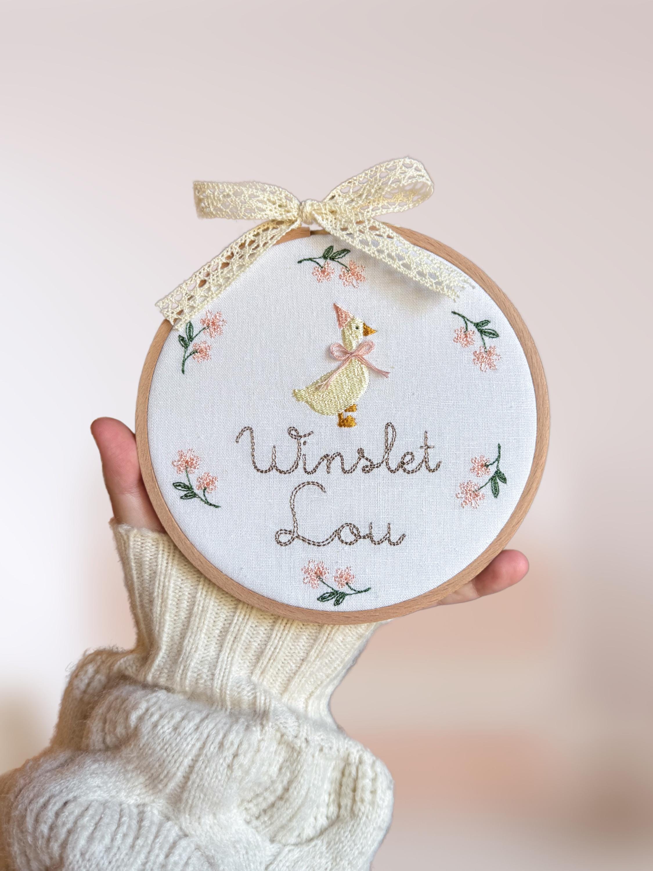 Embroidered plaque with baby’s name, nursery rhyme goose and a minimalist floral wreath | baby name announcement sign and nursery wall decor
