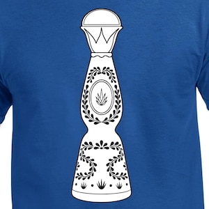 May include: A royal blue t-shirt with a white and black tequila bottle graphic. The bottle design features a crown-like top, a central oval with a plant illustration, and floral patterns. The design is centered on the shirt.