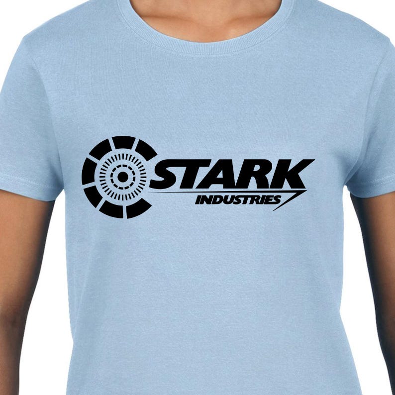 May include: A light blue t-shirt with a black Stark Industries logo. The logo features a stylized circle with a smaller circle inside and the text "Stark Industries" in a bold font.