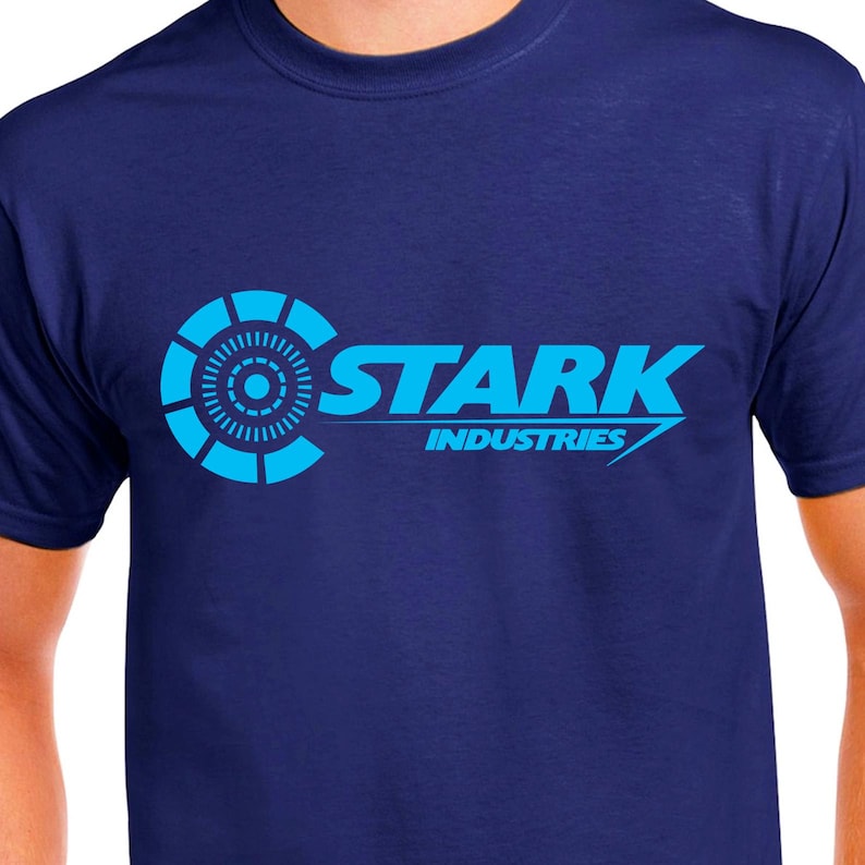 May include: A navy blue t-shirt with a blue and white Stark Industries logo. The logo features a circle with a smaller circle inside and the text "Stark Industries".