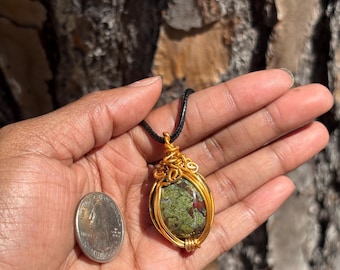 Caged Gold Dragons Blood Pendant