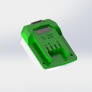 Puede incluir: Cargador de batería verde con una base blanca y el texto "X-20" impreso en él. El cargador tiene una ranura para una batería con cuatro contactos metálicos.