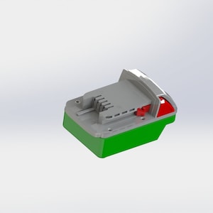 May include: A green and gray battery pack with a red button. The battery pack has a slot for a tool to be inserted.