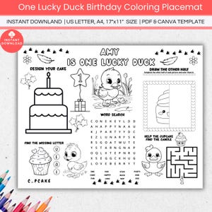 May include: A black and white printable coloring placemat for a child's first birthday. The placemat features a duck, a cupcake, a cake, a word search, and a maze. The text on the placemat reads "Amy is one lucky duck".