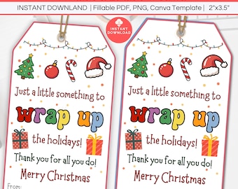 May include: Two Christmas gift tags with a festive design. Each tag features a Christmas tree, ornaments, candy cane, and Santa hat illustrations. Text includes "Just a little something to wrap up the holidays!" and "Merry Christmas."
