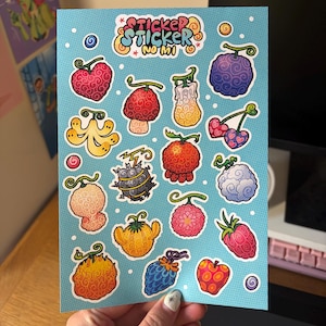 May include: A light blue sticker sheet featuring various colorful, stylized fruit illustrations with swirling patterns. At the top, the text reads Sticker Sticker No Mi. The designs include heart-shaped, round, and elongated fruits in shades of red, yellow, purple, and orange, each with a small green stem.