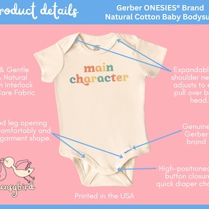 May include: A cream-colored Gerber ONESIES&reg; brand baby bodysuit with the text "main character" printed in rainbow colors. The bodysuit has a ribbed leg opening, expandable lap shoulder neckline, and a high-positioned snap button closure.