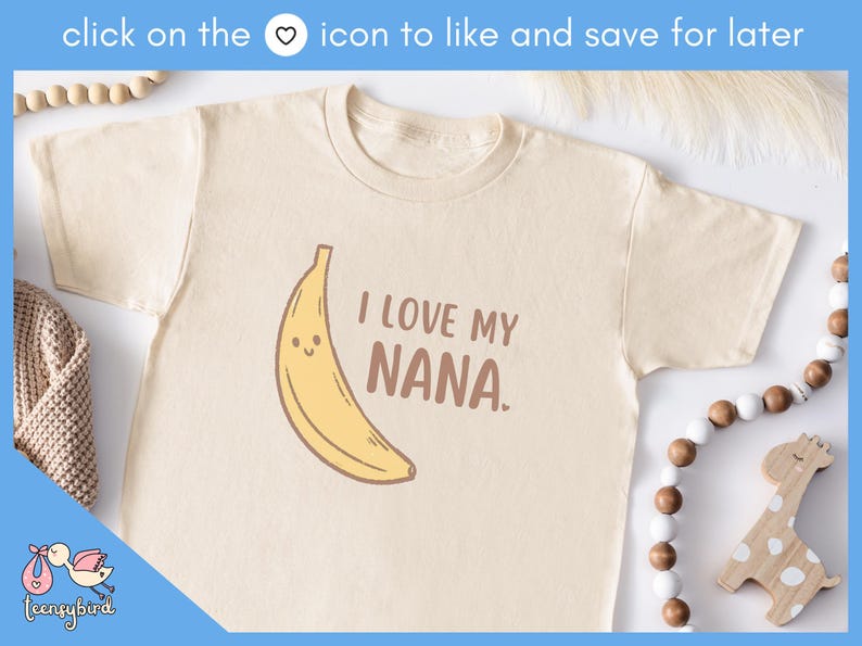 May include: Cream-colored toddler t-shirt with a smiling banana graphic and the text "I LOVE MY NANA." The shirt is made of soft material. A cute and fun design for kids.