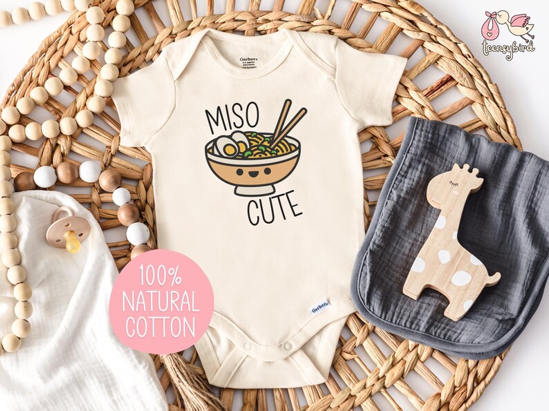 Cute natural cotton Gerber ONESIES® brand baby bodysuit featuring the text MISO CUTE surrounding a smiling kawaii bowl of miso soup.