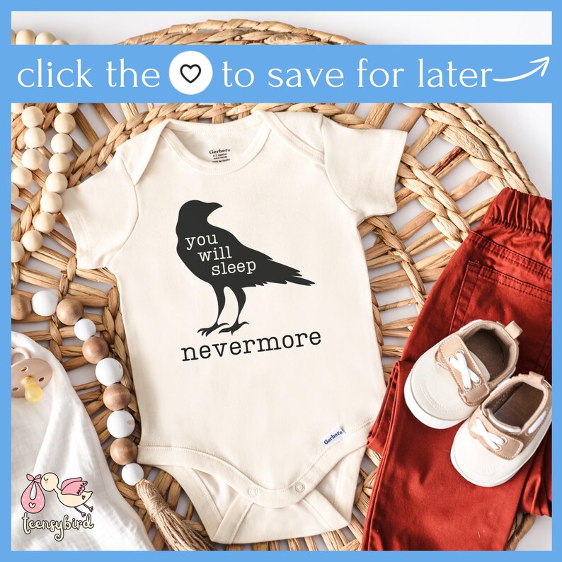 May include: A white baby onesie with a black crow illustration and the text "You will sleep nevermore". The onesie is on a woven wicker surface with a wooden bead garland and a pair of red pants and brown shoes.
