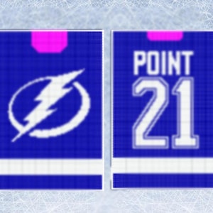 May include: Two blue hockey jerseys. One has a white lightning bolt logo. The other displays "POINT" above the number "21". Both jerseys have a pink accent at the top. The jerseys are likely for ice hockey.