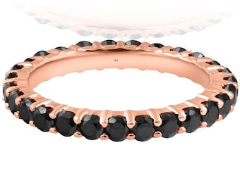 May include: A rose gold eternity band featuring a row of black diamonds. The band is marked with the initials "MJ".