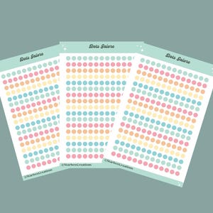 May include: Three sheets of pastel coloured dot stickers with the text "Dots Stickers" printed on each sheet.
