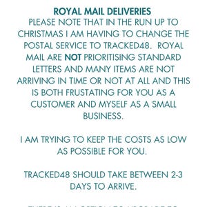 May include: A white background with text in a teal font. The text includes a red banner that says "ATTENTION PLEASE!". The text explains changes to postal services for Christmas, including the use of Tracked48 and options for faster delivery.