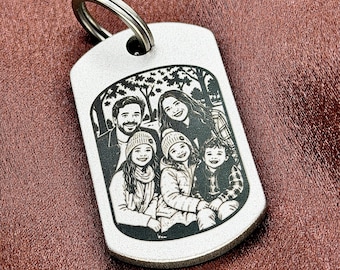 May include: A silver-toned metal dog tag keychain featuring a laser-engraved black and white illustration of a family of four. The rectangular tag has rounded corners and a circular metal split ring attached at the top for keys.