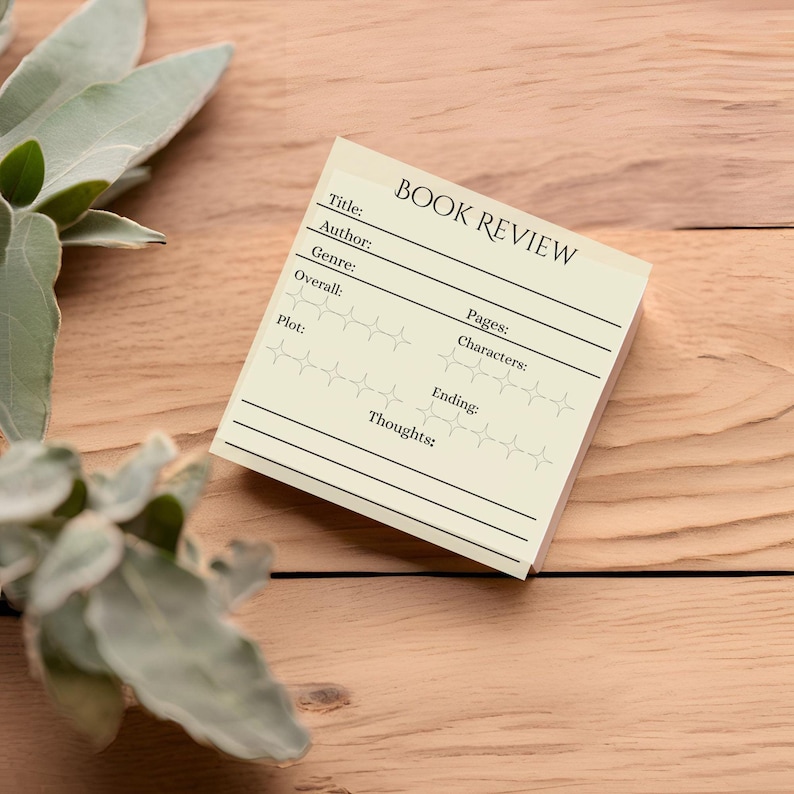May include: A yellow book review template with blank lines for title, author, genre, overall rating, pages, characters, plot, ending, and thoughts. The template is on a wooden surface.