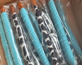 1 Dozen Cow Print & Light Blue/Drizzled in Light Blue Chocolate Pretzels- Mixture of both- 6 Each. HEAT SENSITIVE!