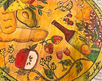 Hand painted 12" diameter lazy susan. Displaying kitchen staples, wine bottle, bread and fruit.  A beautiful addition to your kitchen area.