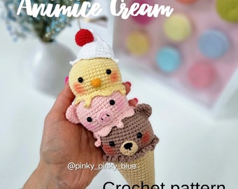 May include: A crocheted ice cream cone with a yellow chick, pink pig, and brown bear on top. The cone is made of brown yarn and the animals are made of different colored yarns. The text "Animice Cream" and "Crochet pattern" are visible in the image. The image is captioned with the text "@pinky_pinky_blue".