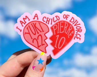 May include: A pink heart-shaped sticker with the text "I am a child of divorce" and two broken hearts inside. One heart says "Yuki 22" and the other says "Pierre 10".