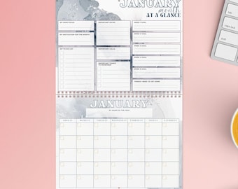 May include: A printable January calendar planner with a watercolor background. The planner includes sections for goals, to-do lists, important dates, and important calls. The calendar is a grid with boxes for each day of the month.